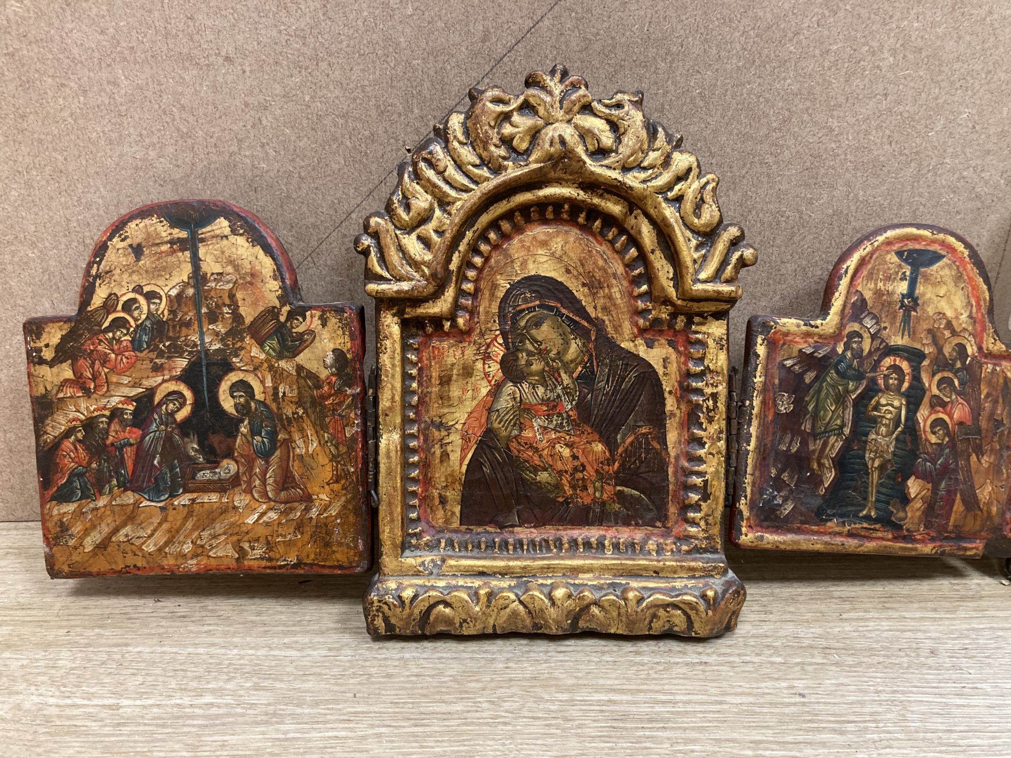 A tempera on wood triptych icon, height overall 25cm and a single Virgin and child icon, 21 x 17cm